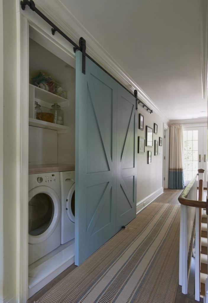 Beautiful blue barn door that hides a washer and dryer