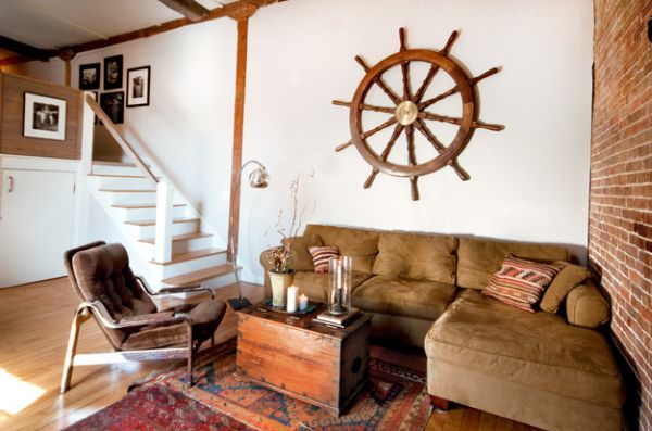 Eclectic living room with exposed brick wall and a large ship wheel