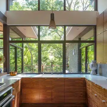 Natural light or a sleek backplash made of glass tiles in kitchen 