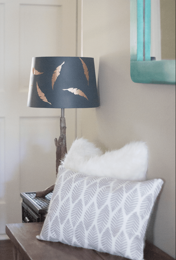 Feather-Accented Entryway with a Lamp and Soft Pillows