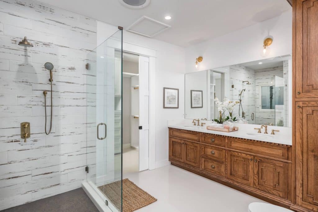 large bathroom with carved wood cabinets and shower