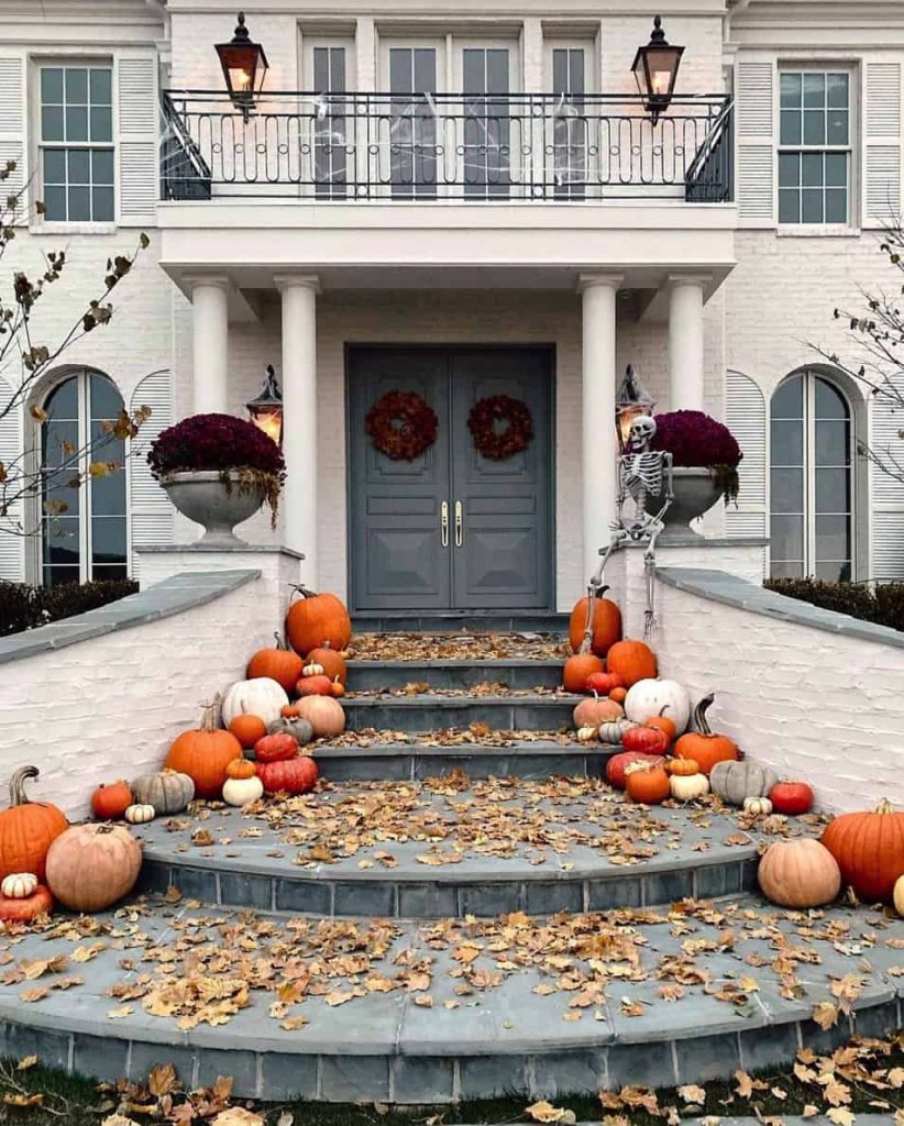 porch and line up the mix of orange and white pumpkins at the steps