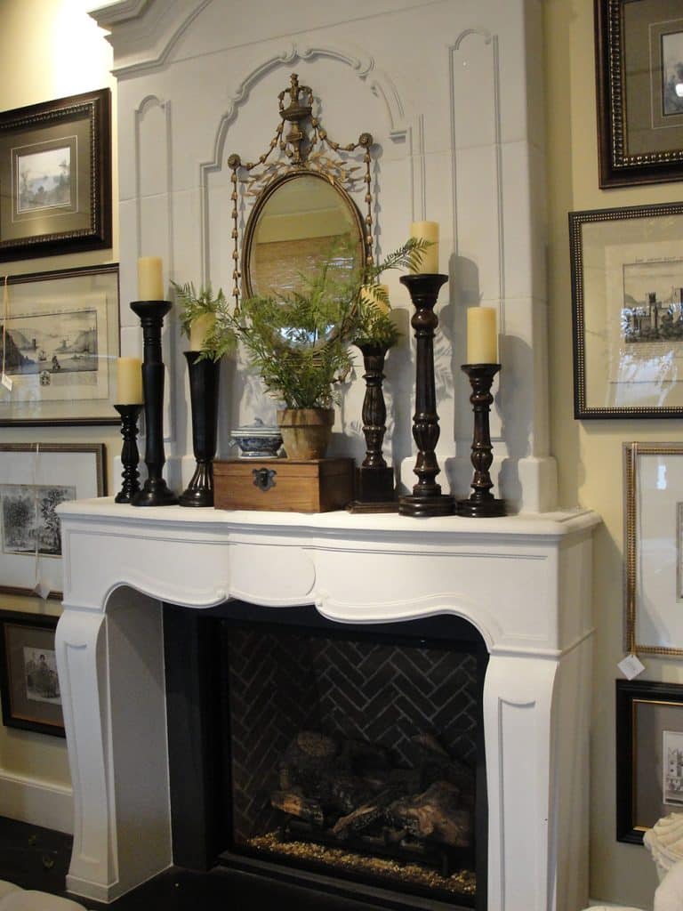 Sconce on Either Side of The Mantel with A Pair of Candlesticks