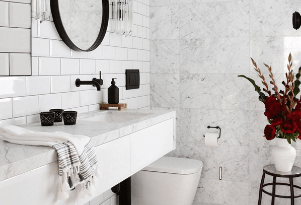 white marble bathroom and black mirror 