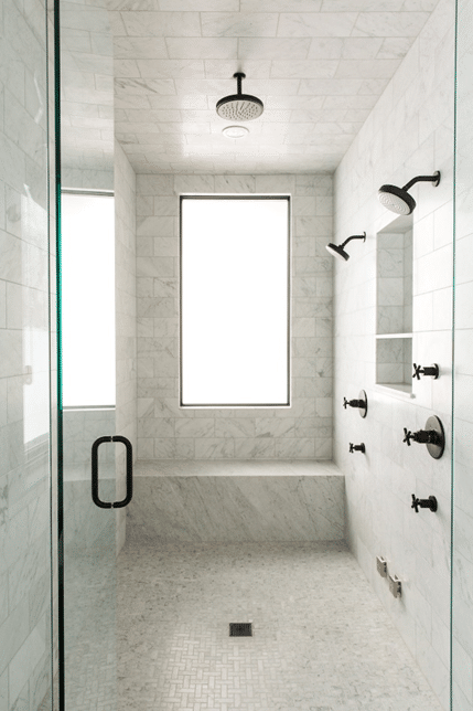 marble bathroom with dark fixtures
