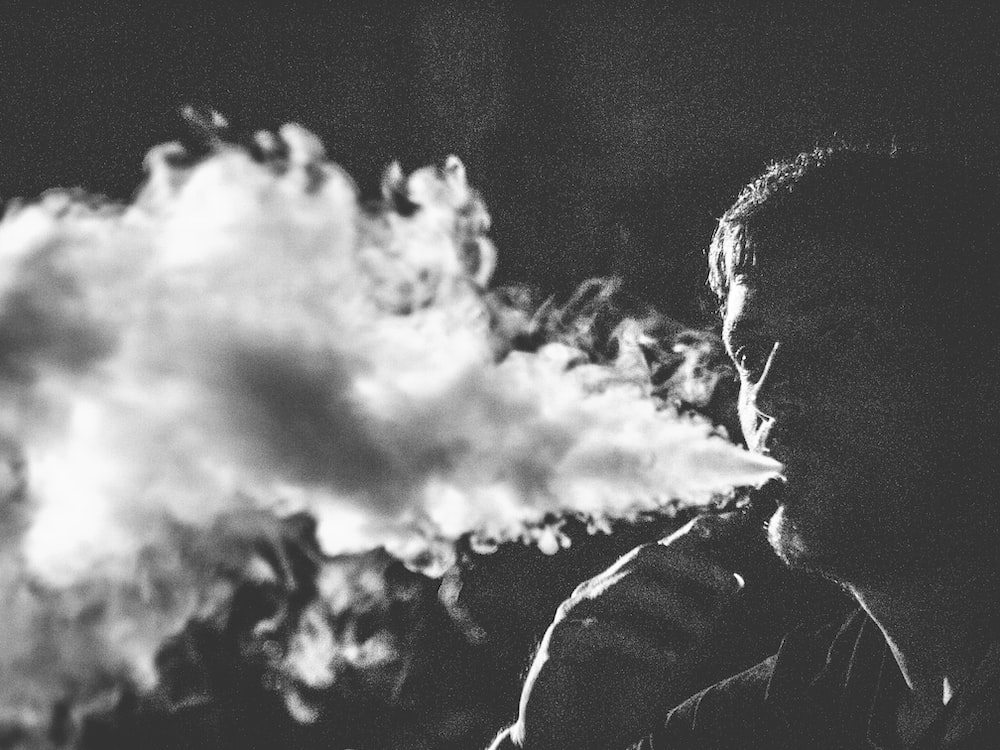 grayscale photography of smoking man