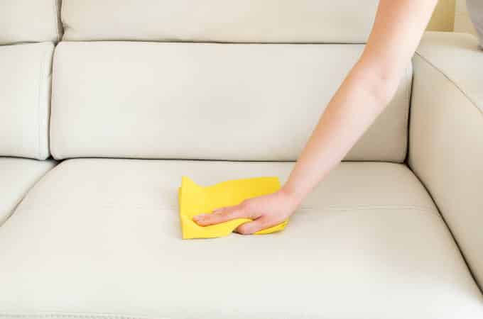 cleaning a beige sofa