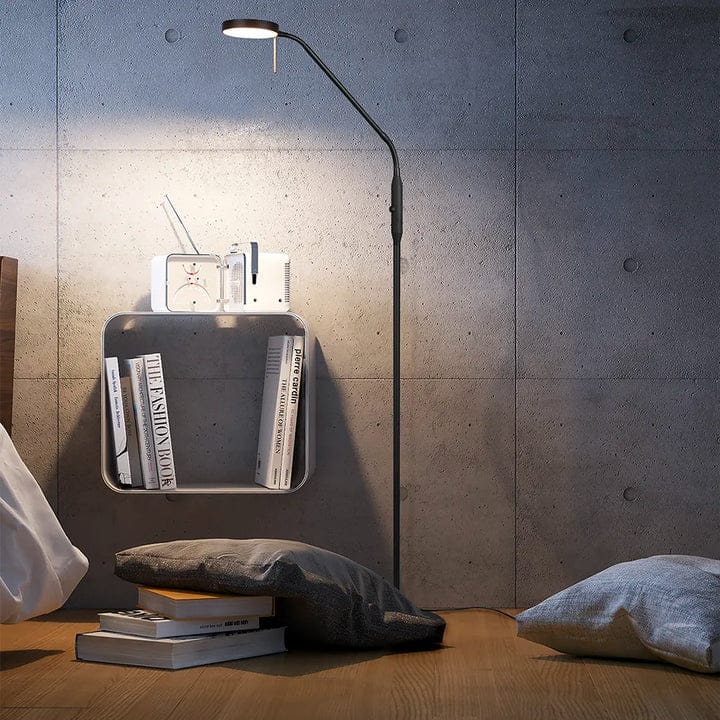 A cozy bed with a stylish lamp on top,