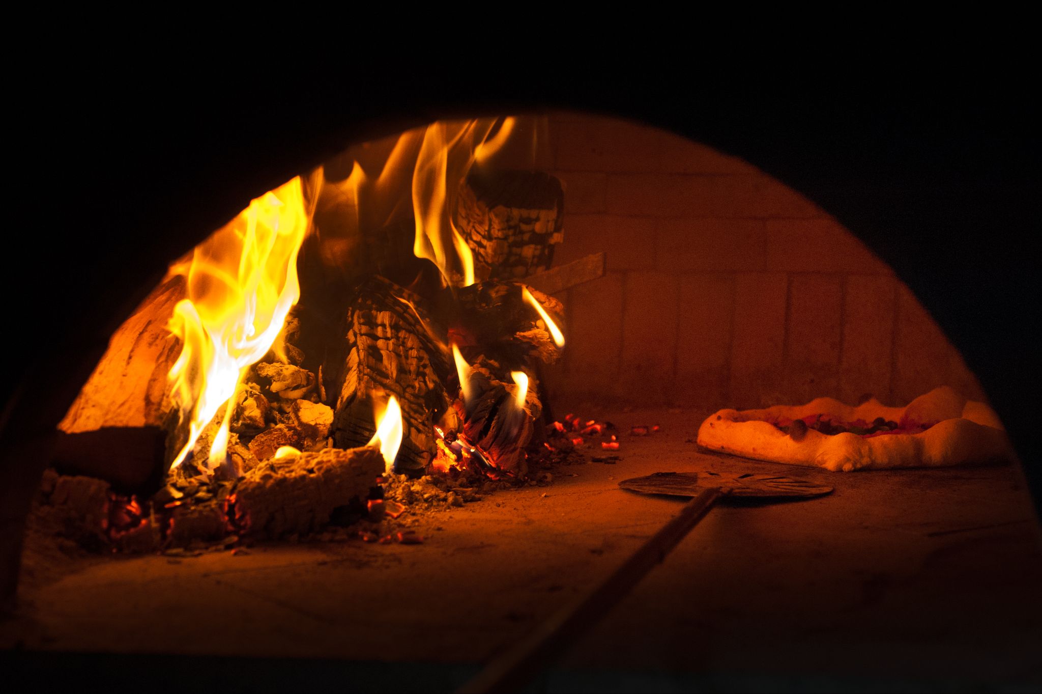 pizza baking in a Neapolitan-style oven