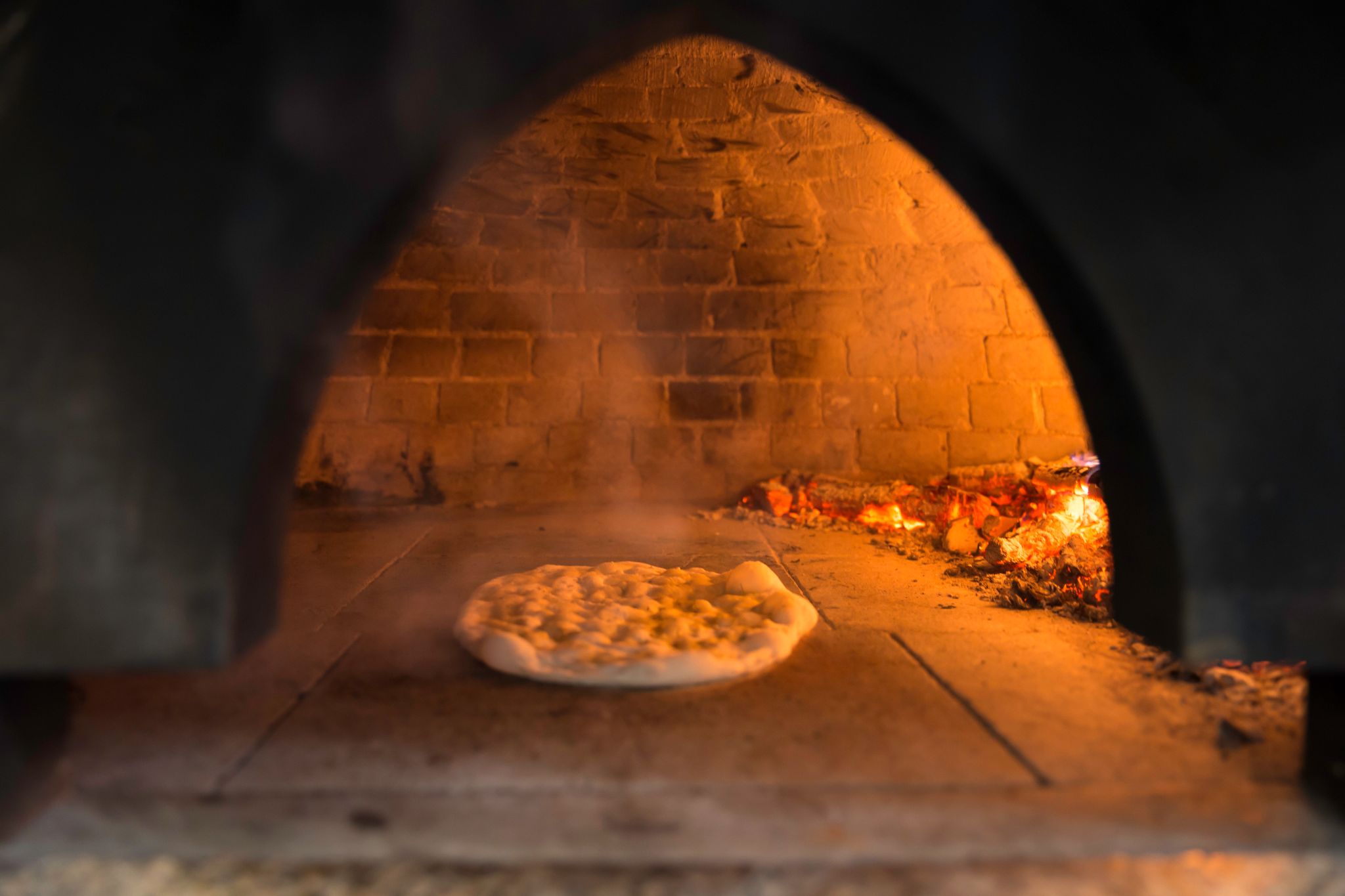 making pizza in a wood-fired garden oven