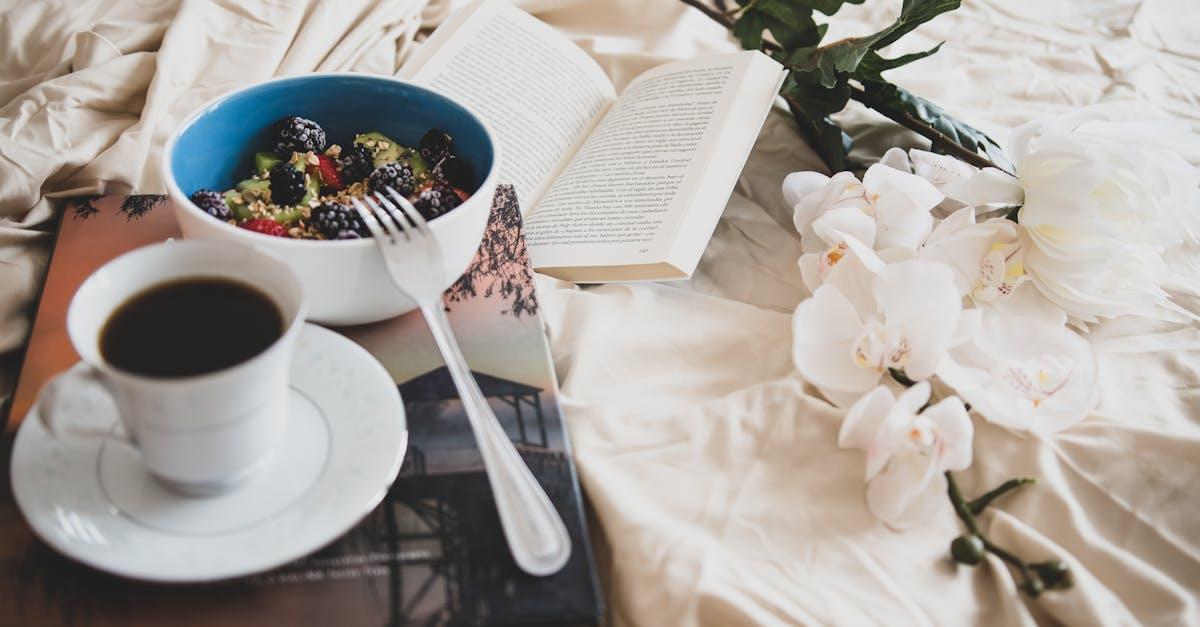 Relax with a book, a cup of coffee, and a fresh fruit bowl on a cozy morning.