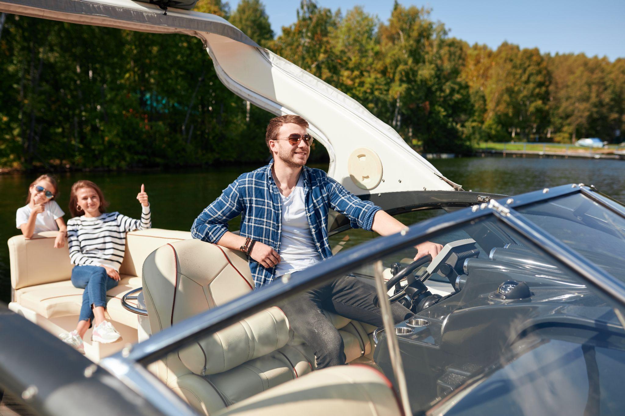 father with adorable daughter and wife resting on a big boat.