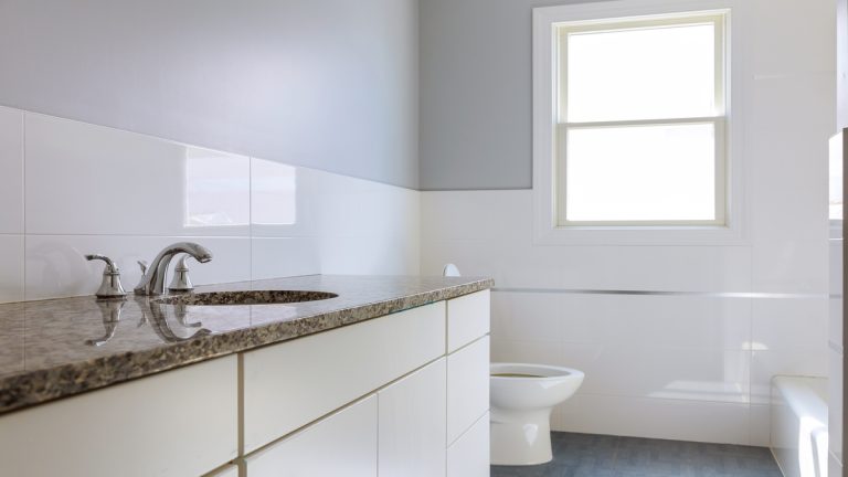 Master bath in new construction home dark wood cabinetry