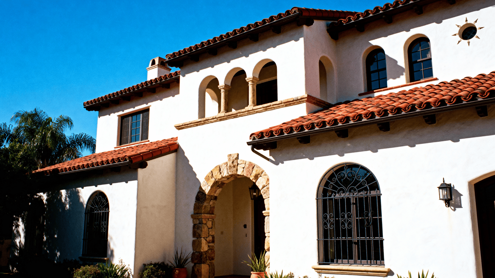 white stucco walls paired with red clay tile roofs