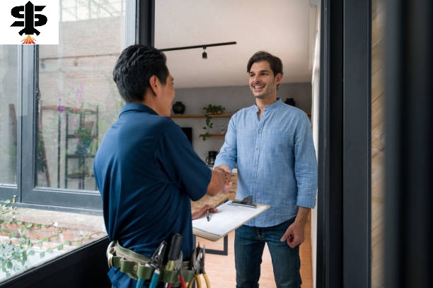Latin American Electrician or plumber greeting a client with a handshake at the door of his house
