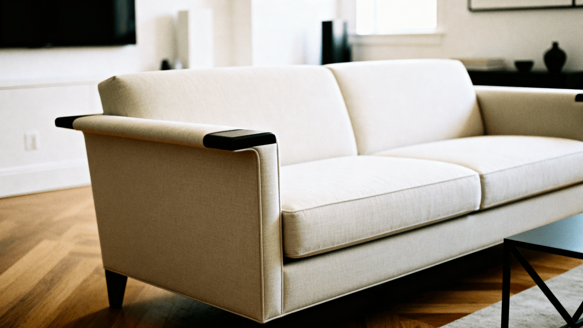 Tuxedo sofa with square arms and sleek lines in a modern minimalist space.