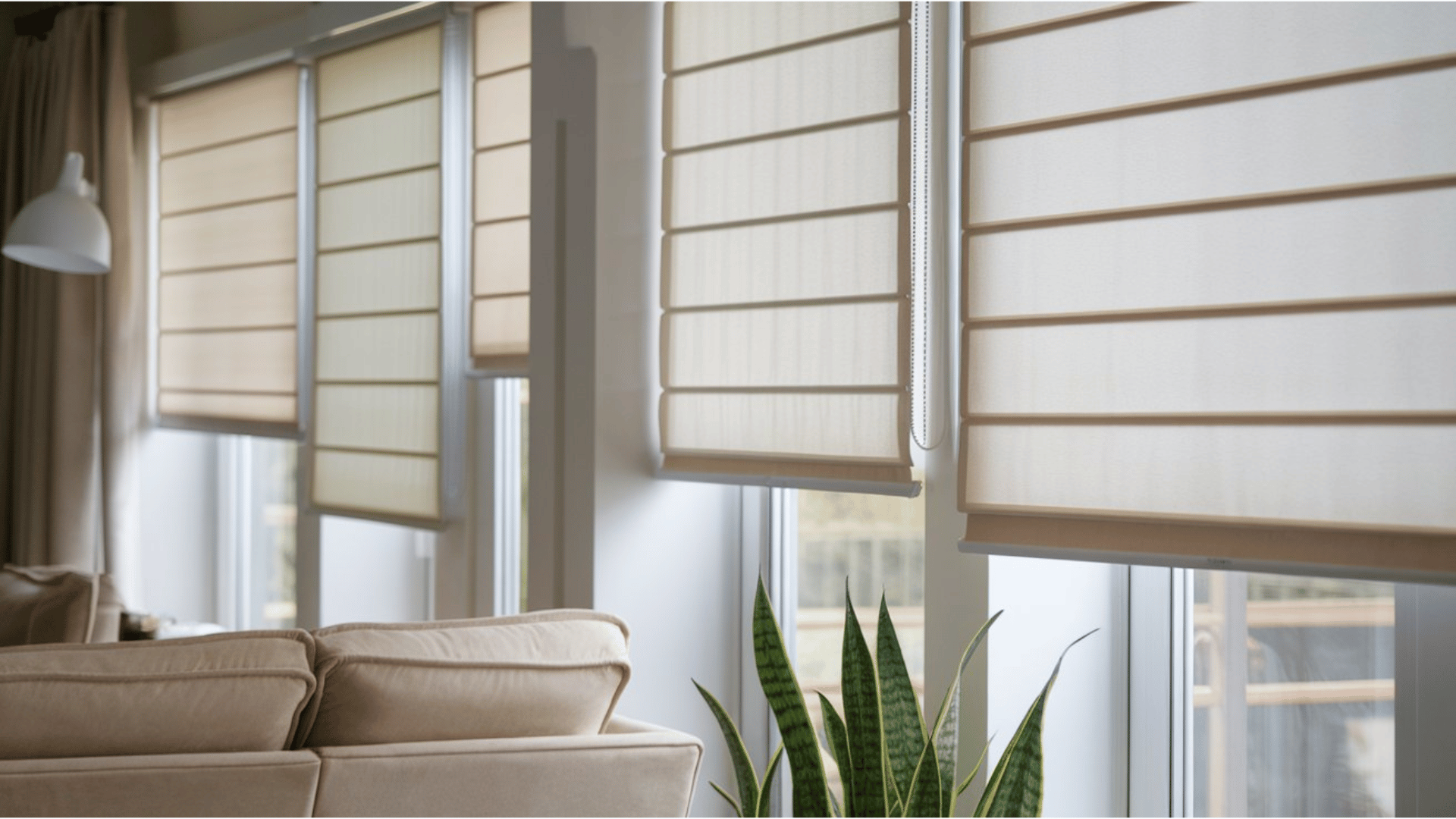 elegant cream roller blinds with a horizontal pleated design in a bright living room, featuring a sofa and snake plant