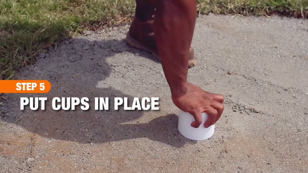 hand placing golf cup in ground, text “Step 5 Put Cups in Place.”