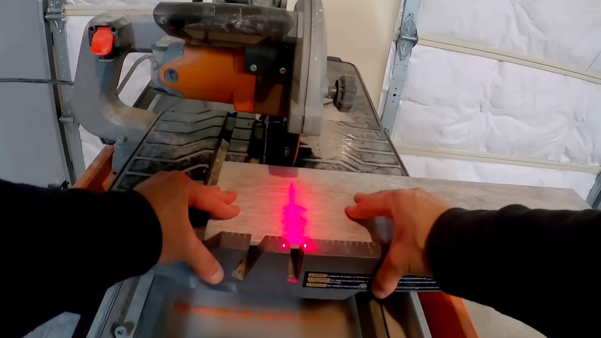 man planning layout and pre-cutting tiles to prepare for tile installation