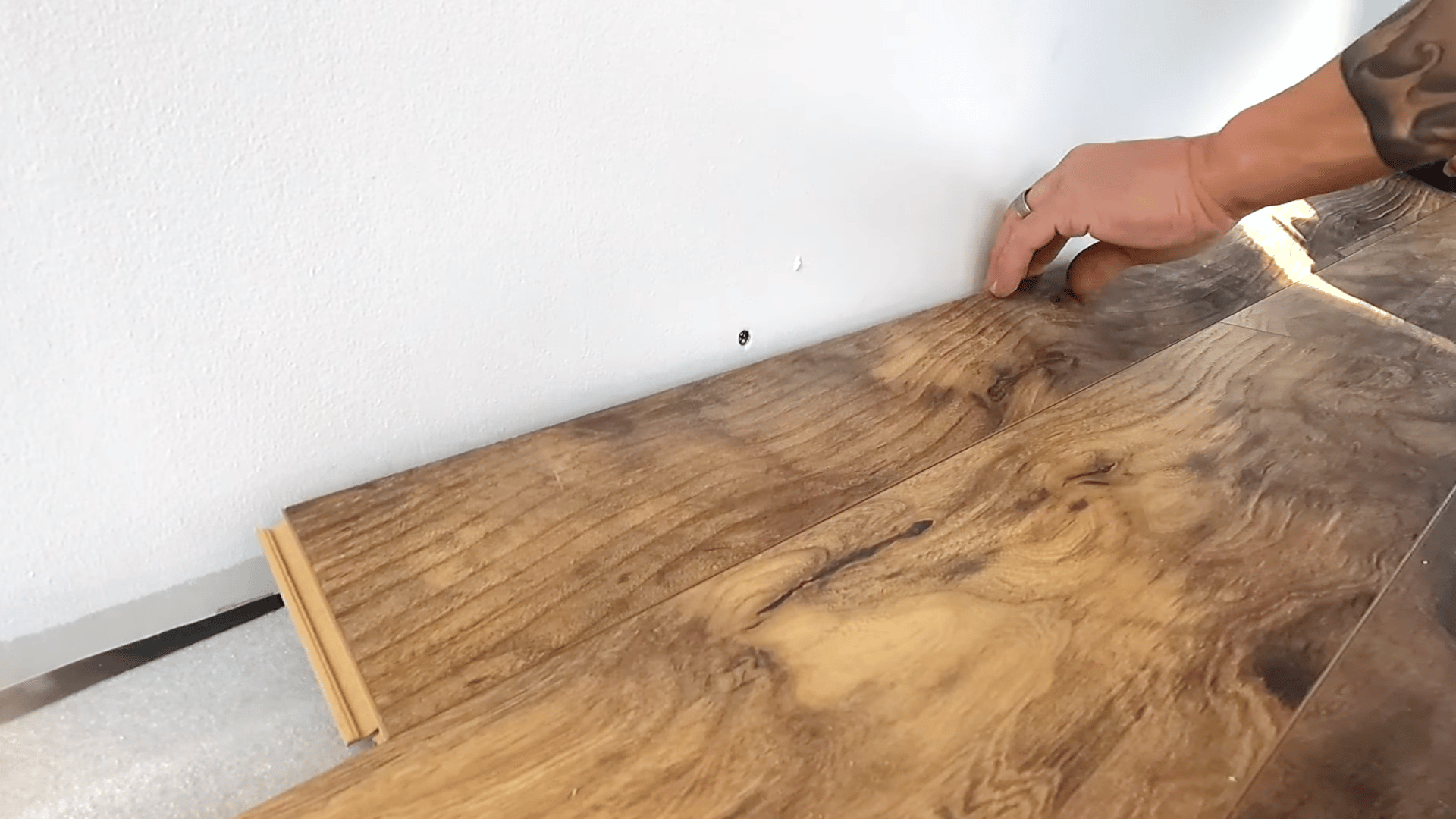 measure from the wall to the last plank and subtract the expansion gap.