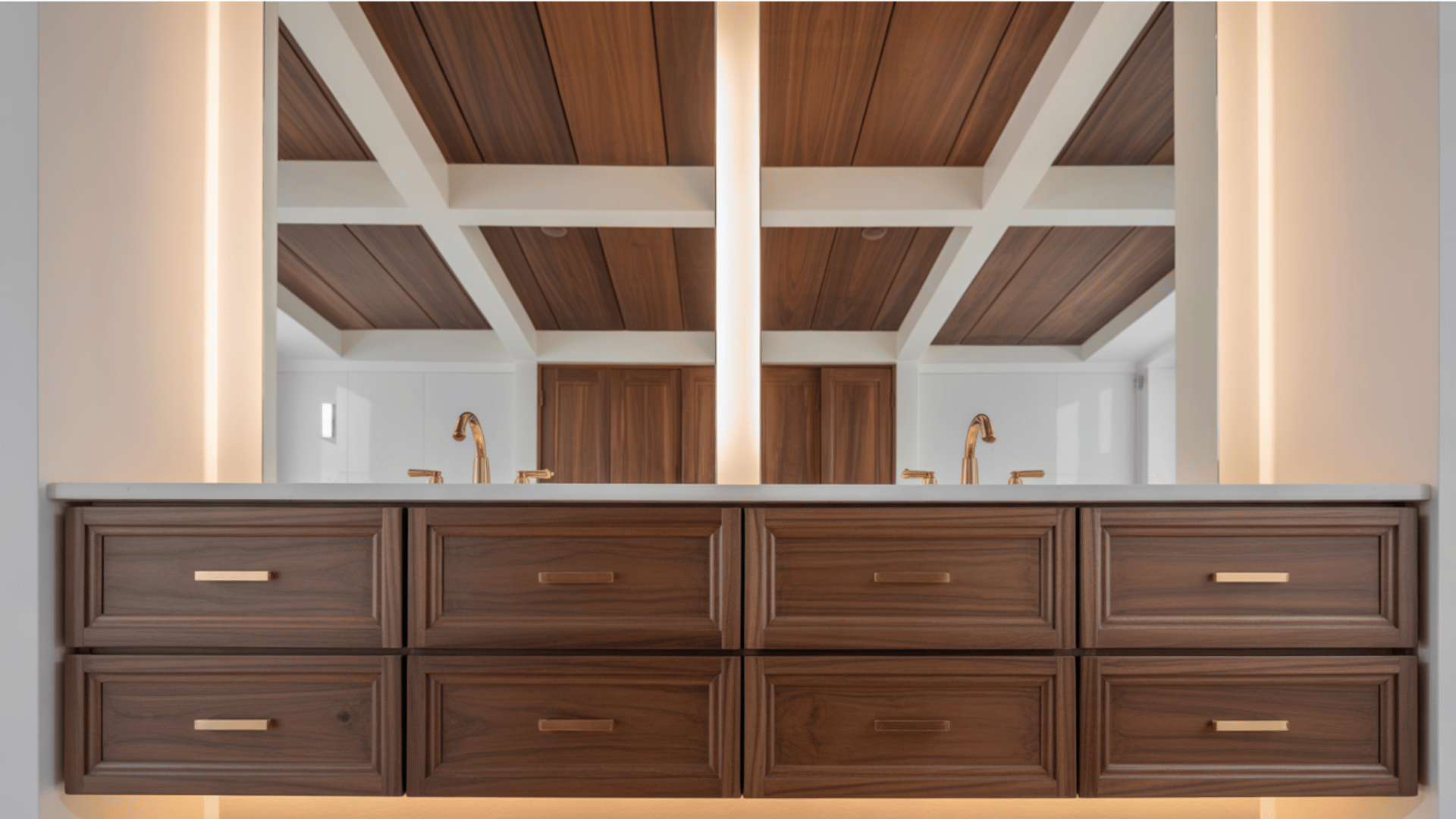 modern bathroom vanity with dark wood drawers, gold faucets, and a large mirror reflecting a white and wood ceiling.