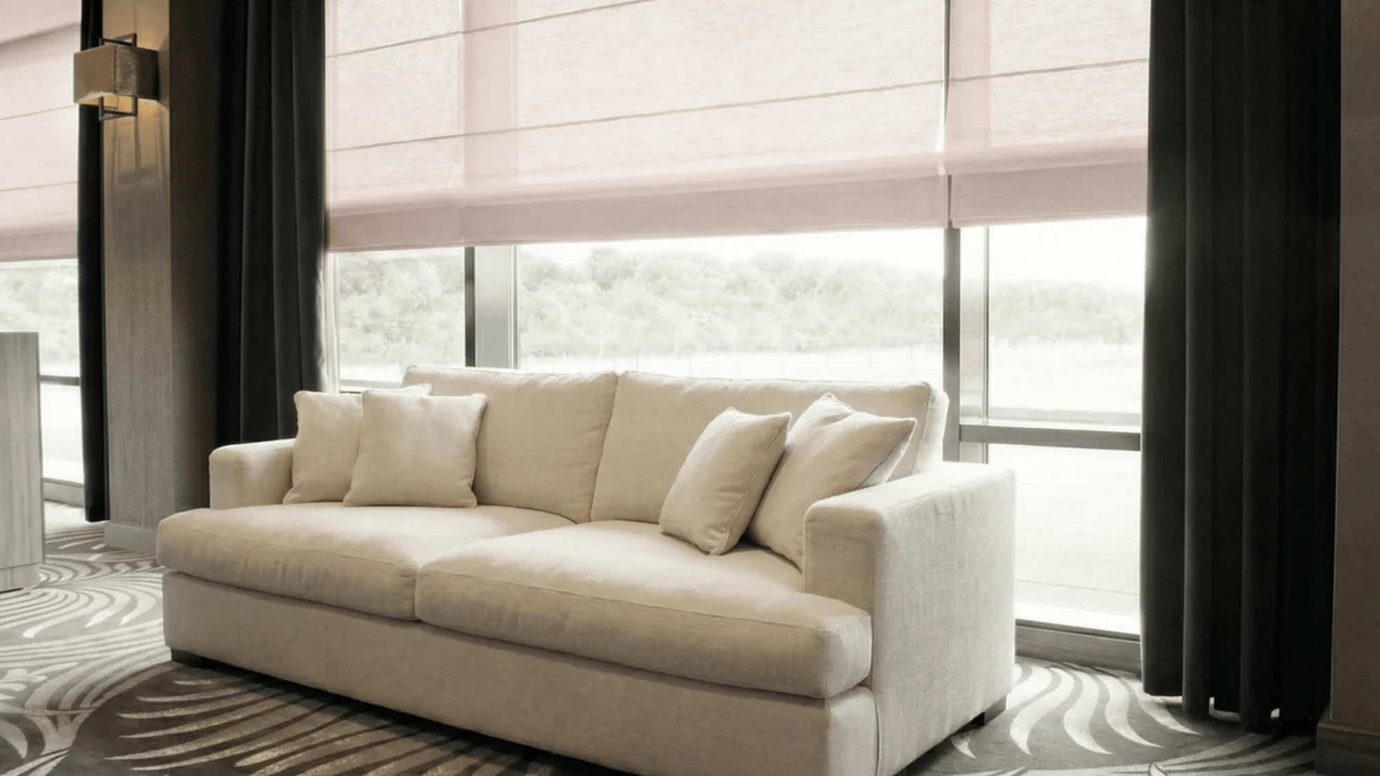 solar Roman shades in a modern living room, offering light filtering and privacy while maintaining a soft, airy feel