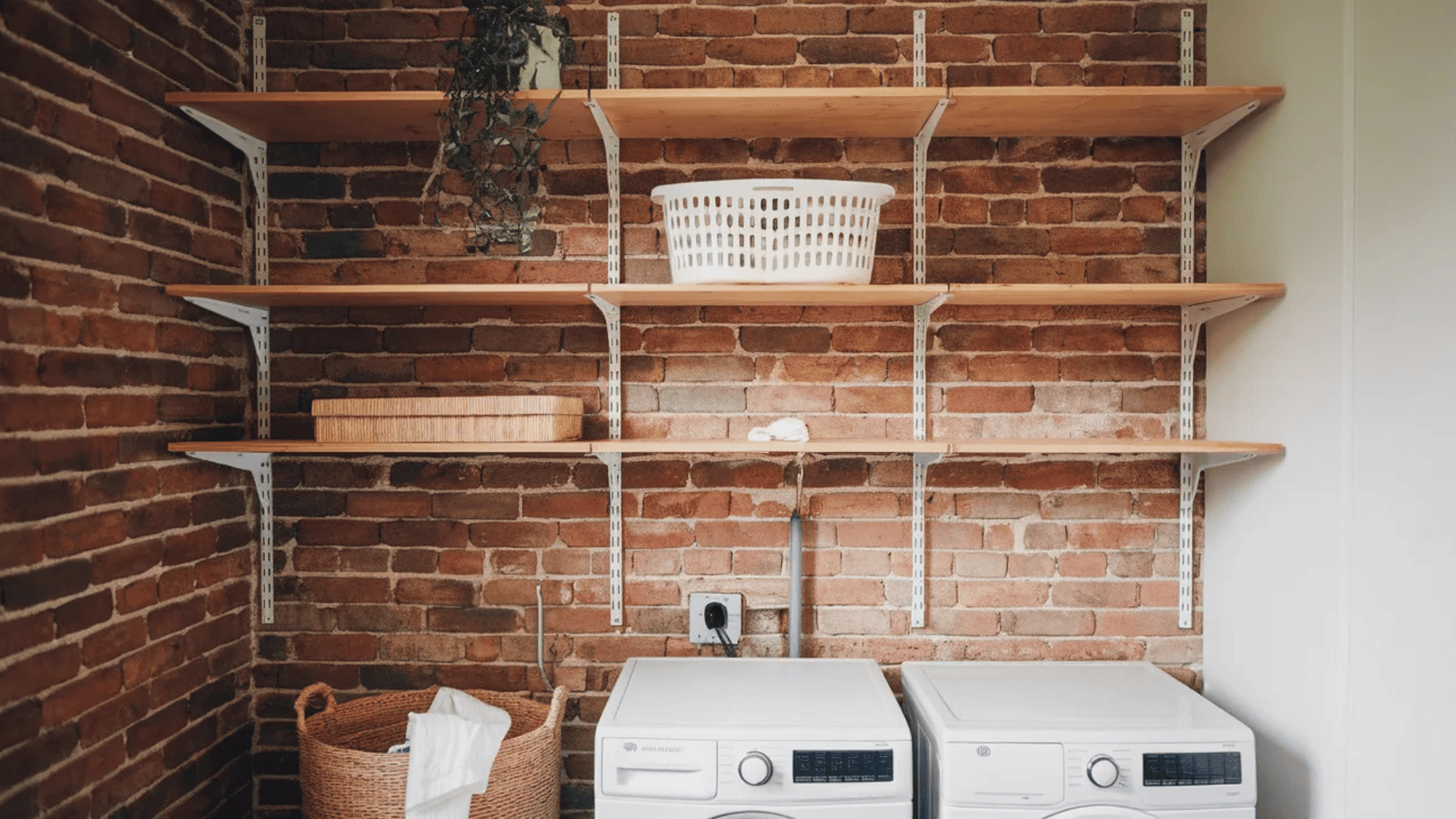 wall shelving in a laundry room with wooden shelves against a brick wall, featuring baskets and storage containers