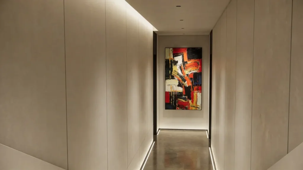 A view down a long hallway leading to a large, colorful piece of abstract art on the far wall, serving as a clear focal point