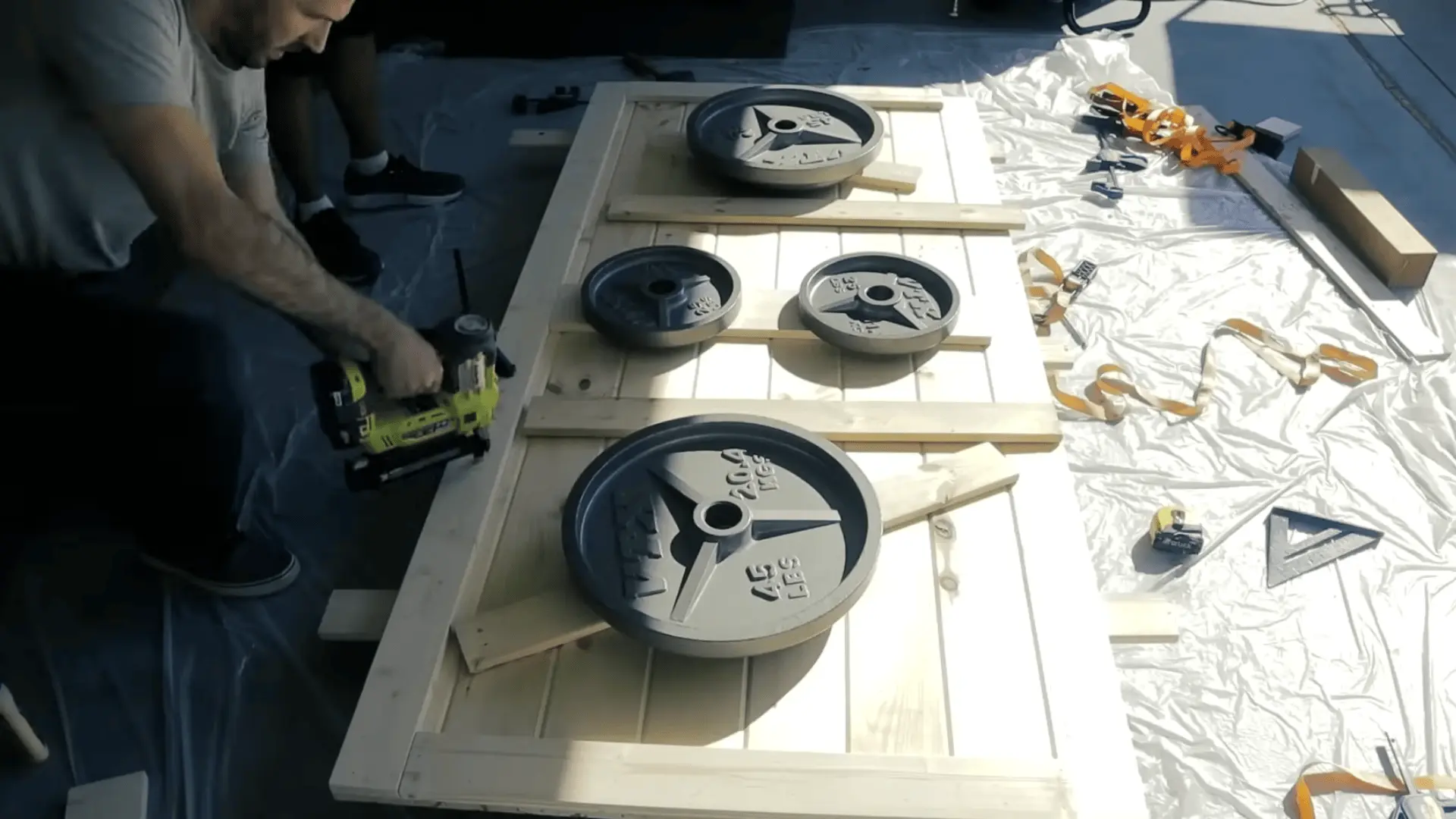 Attaching horizontal support boards and side pieces to strengthen the barn door structure.