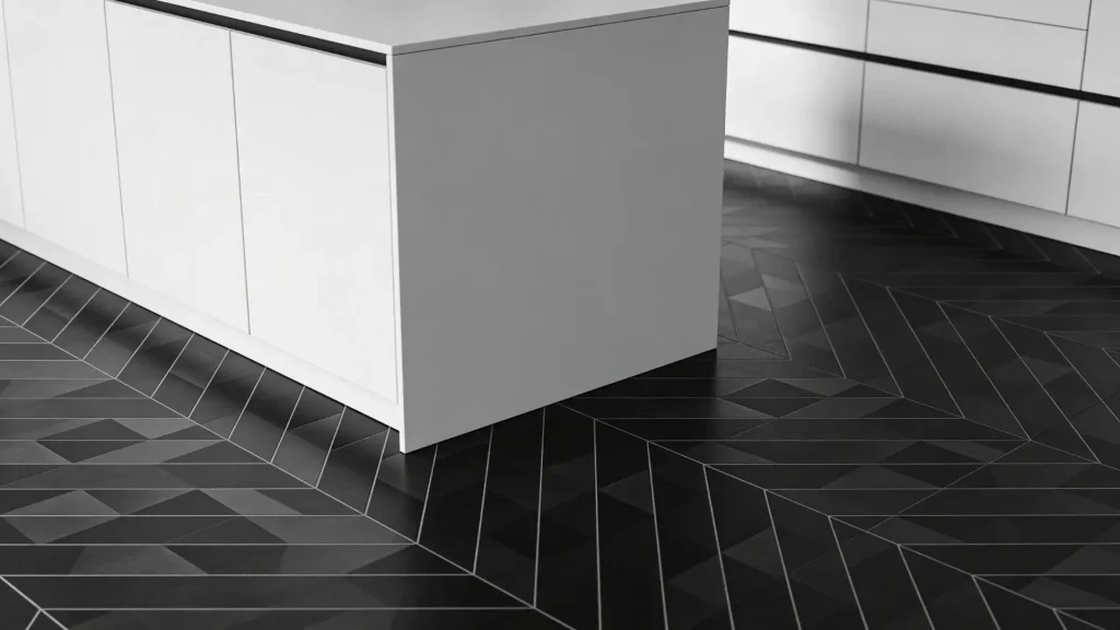 Black geometric tiles forming structured patterns on a kitchen floor with modern cabinets