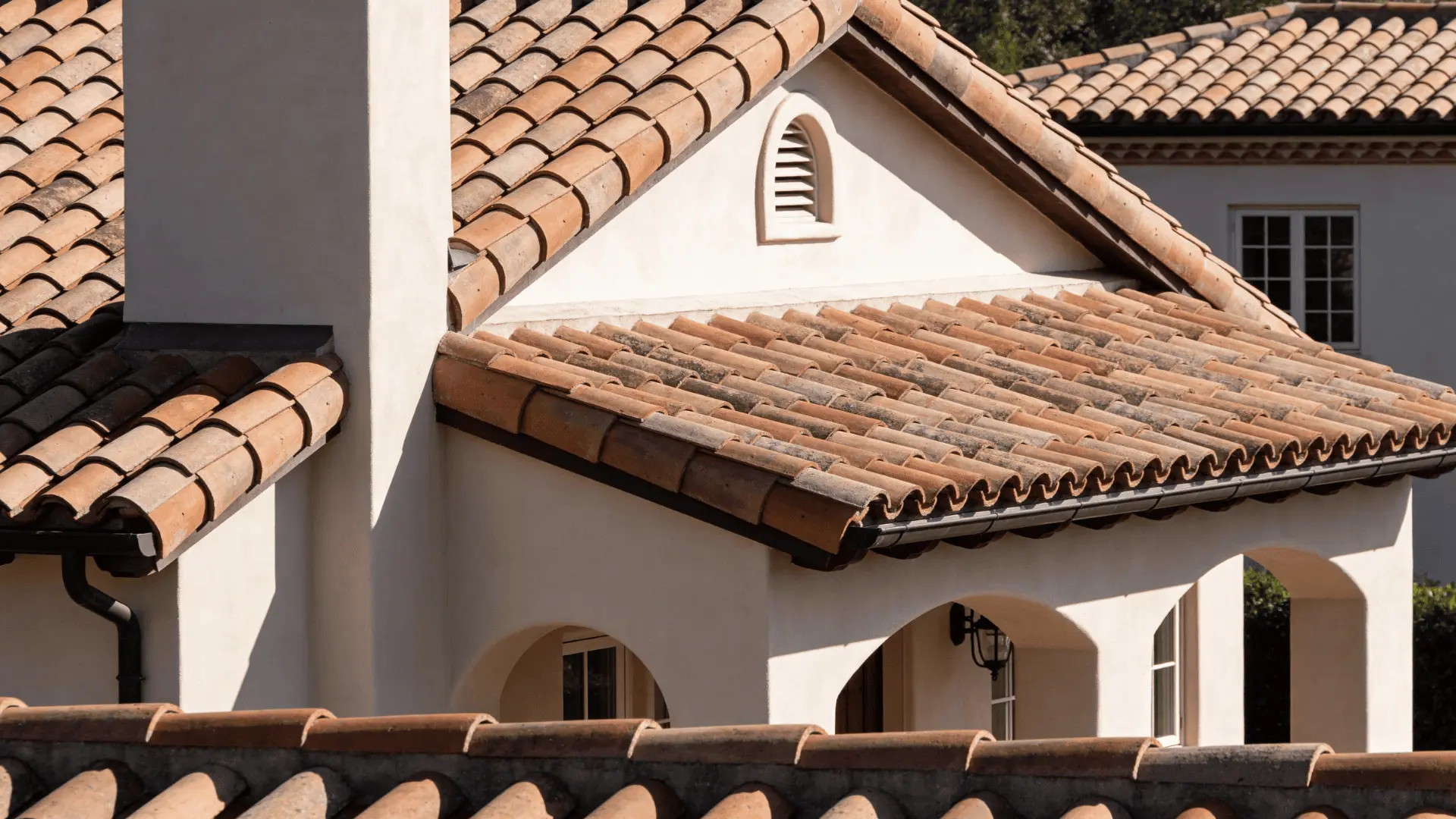 Clay and concrete tiles installed on a roof showing curved and flat tile patterns