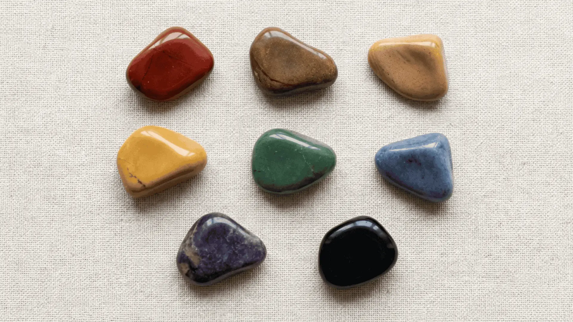 Collage of jasper stones in red, brown, yellow, green, blue, purple, and black colors arranged separately