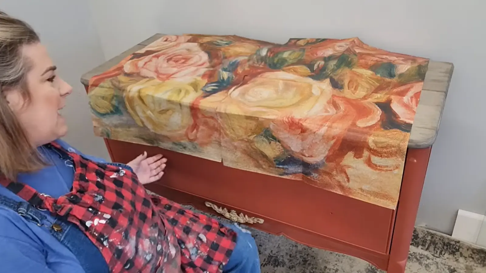Large floral decoupage paper laid across the dresser drawer fronts to plan placement before attaching.