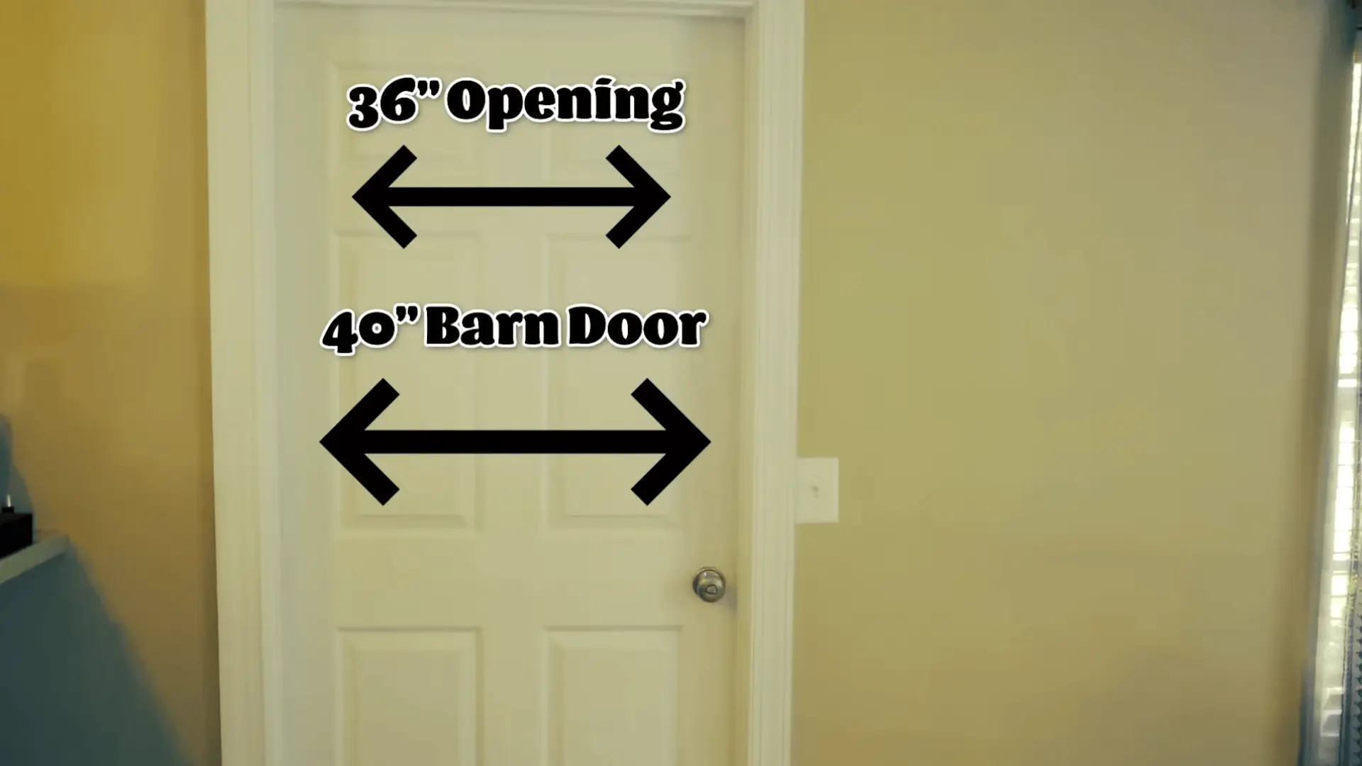 Measuring the doorway to determine barn door width and height before building the frame.