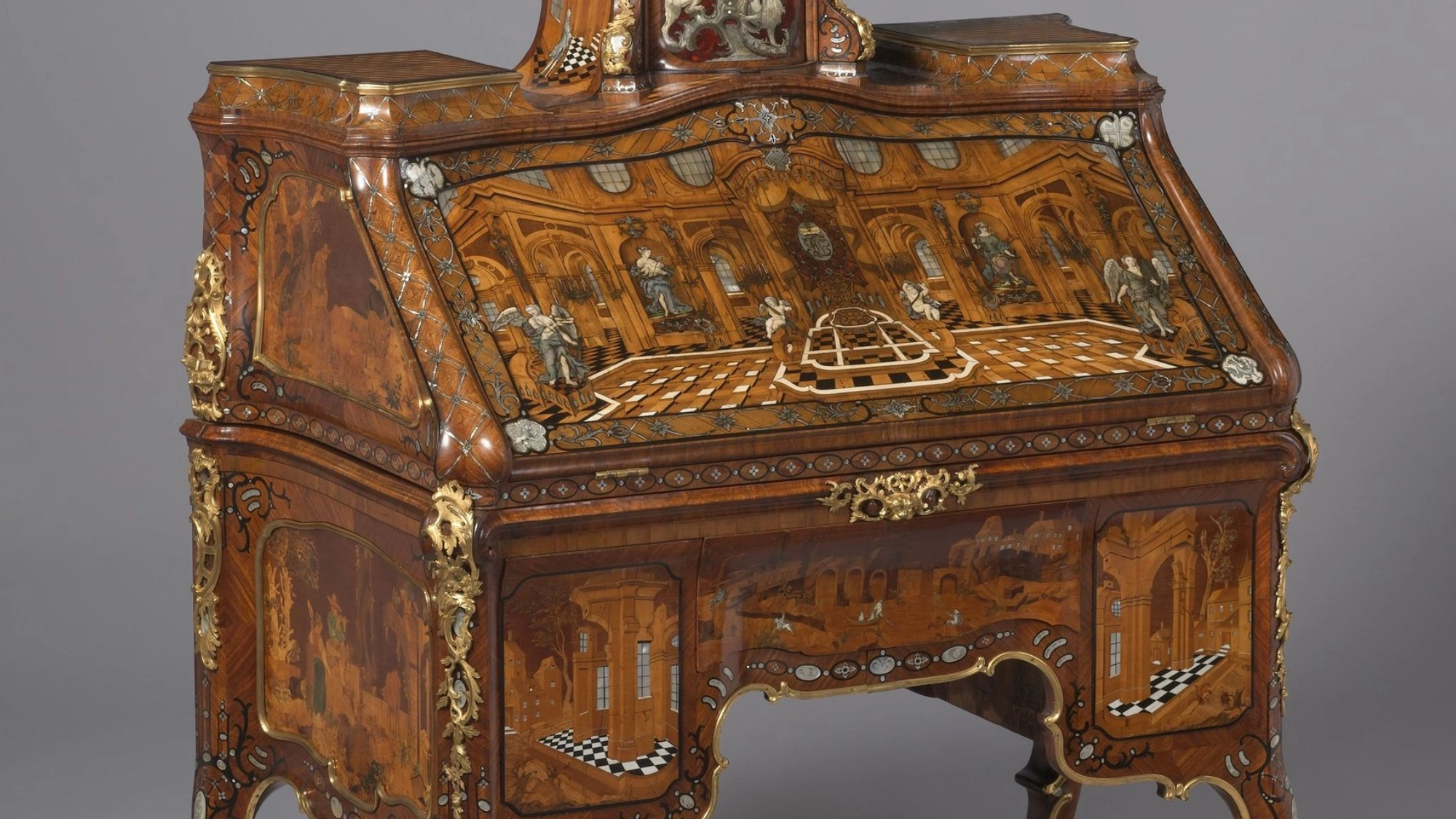 Ornate 18th-century Rococo bureau with marquetry inlay, gilded bronze mounts, and curved cabriole legs