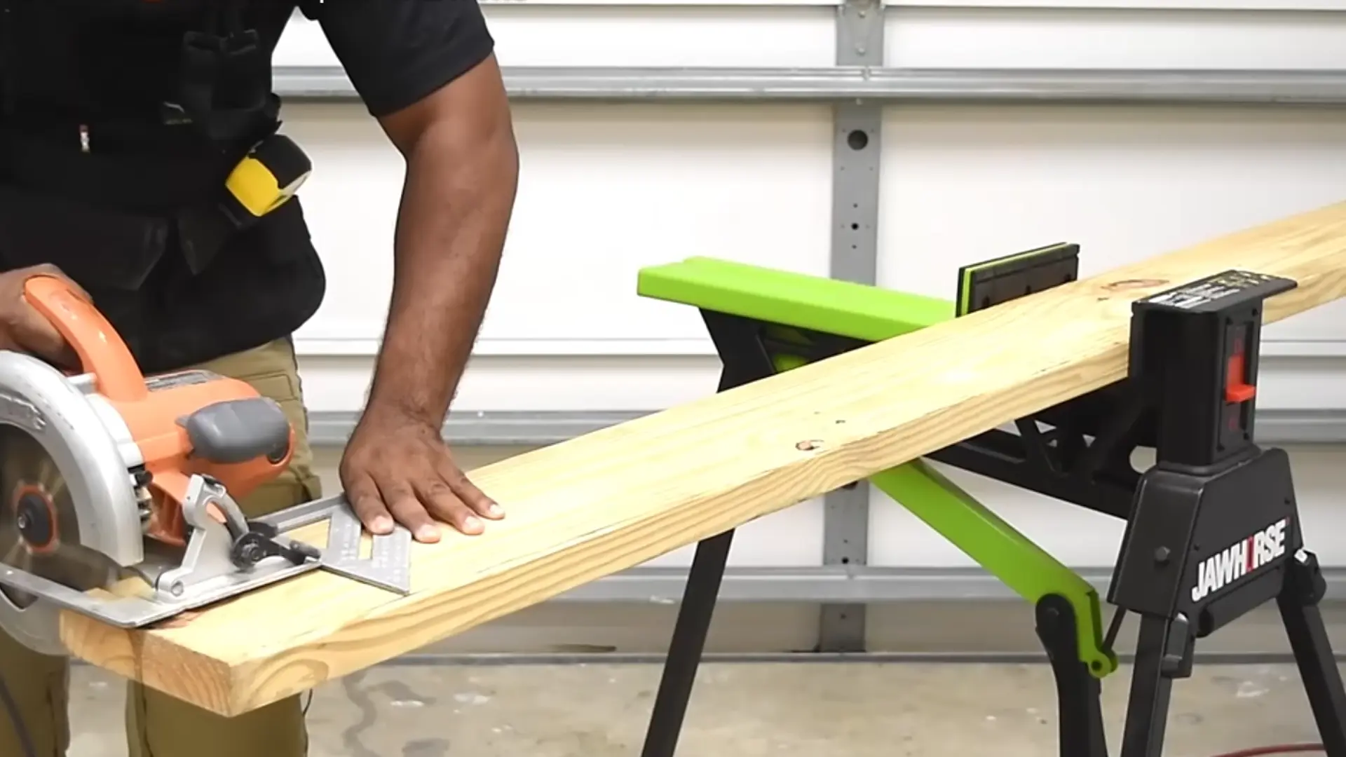 Wood board marked and being cut into equal pieces with a circular saw on a workbench.