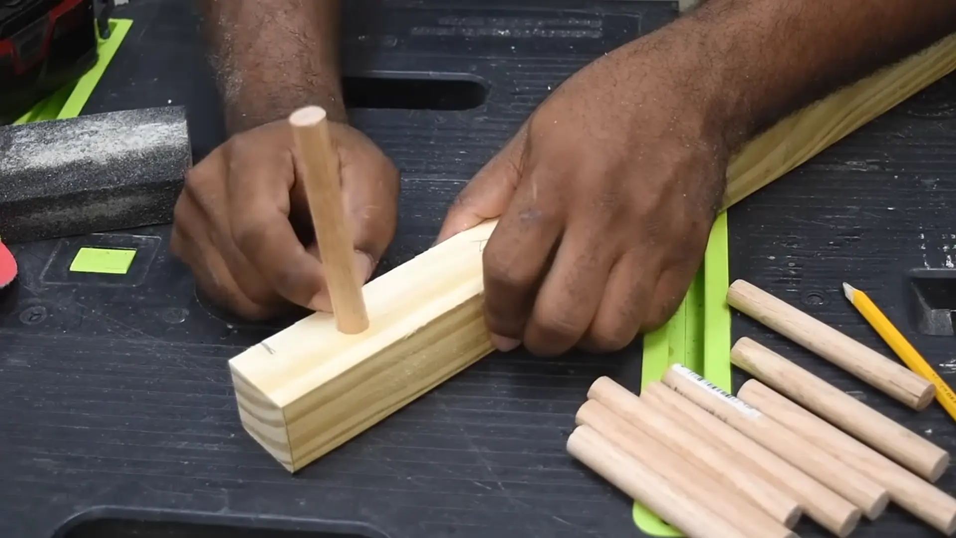 Wooden dowel held in drill while sandpaper smooths the surface for easier fitting.