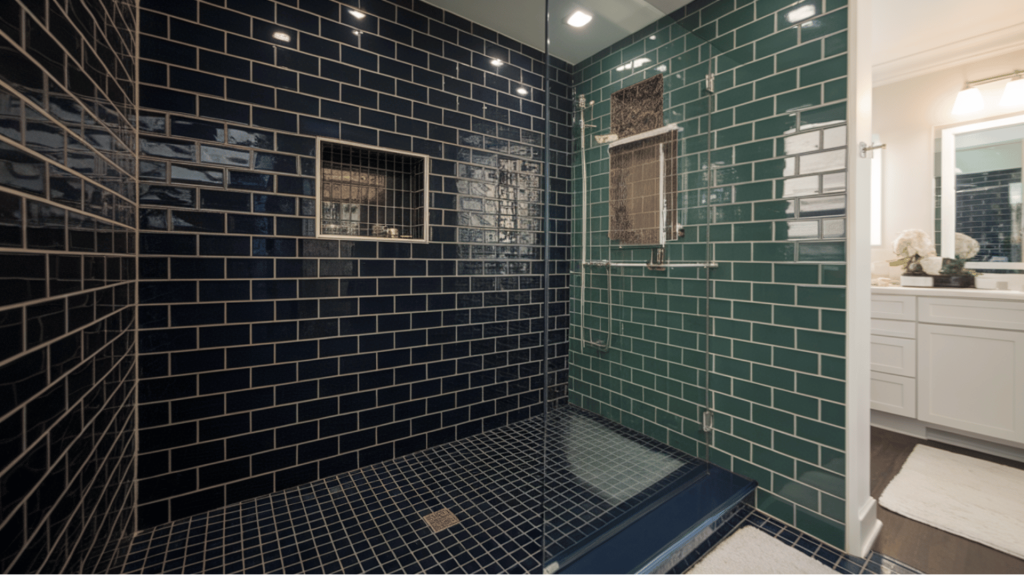 a bold walk-in shower featuring navy and black tiles, with a built-in niche and sleek glass partition.
