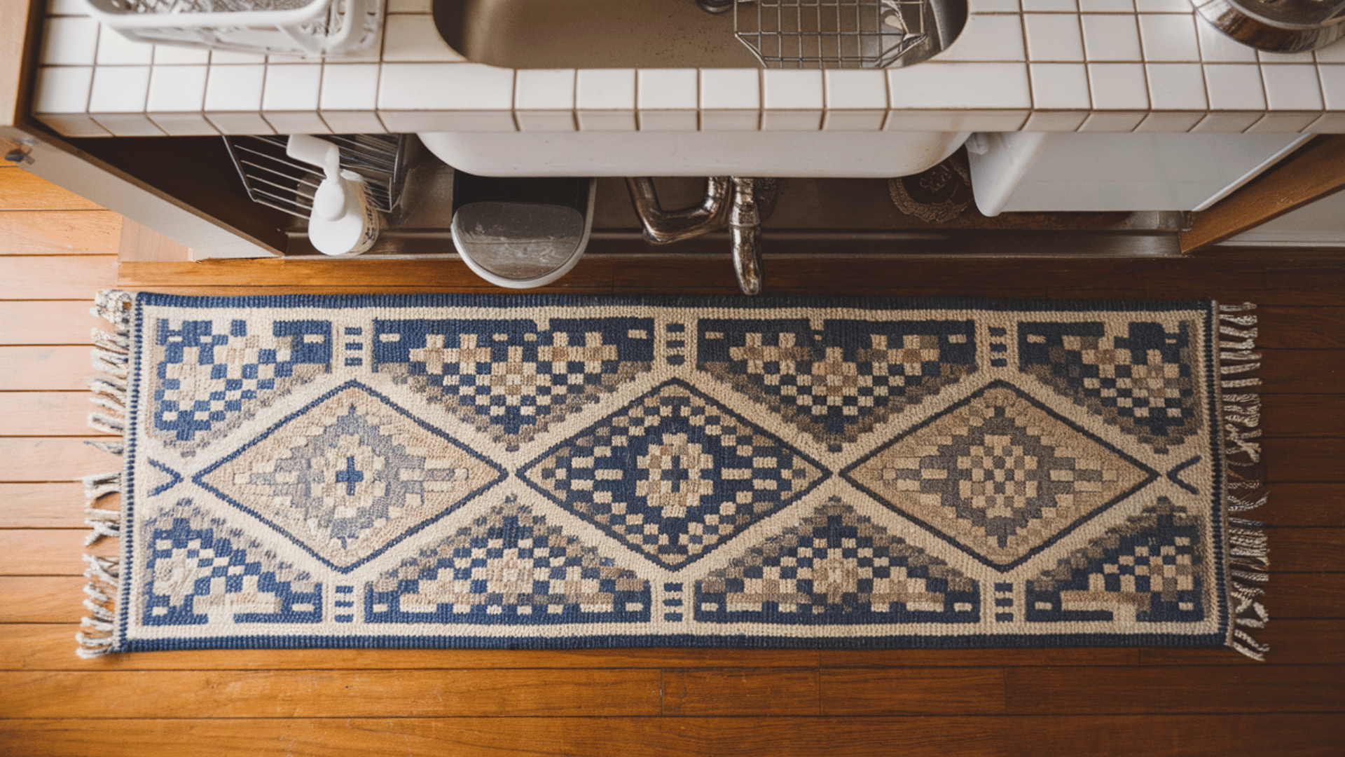 a long, narrow runner rug stretching down on the kitchen floor
