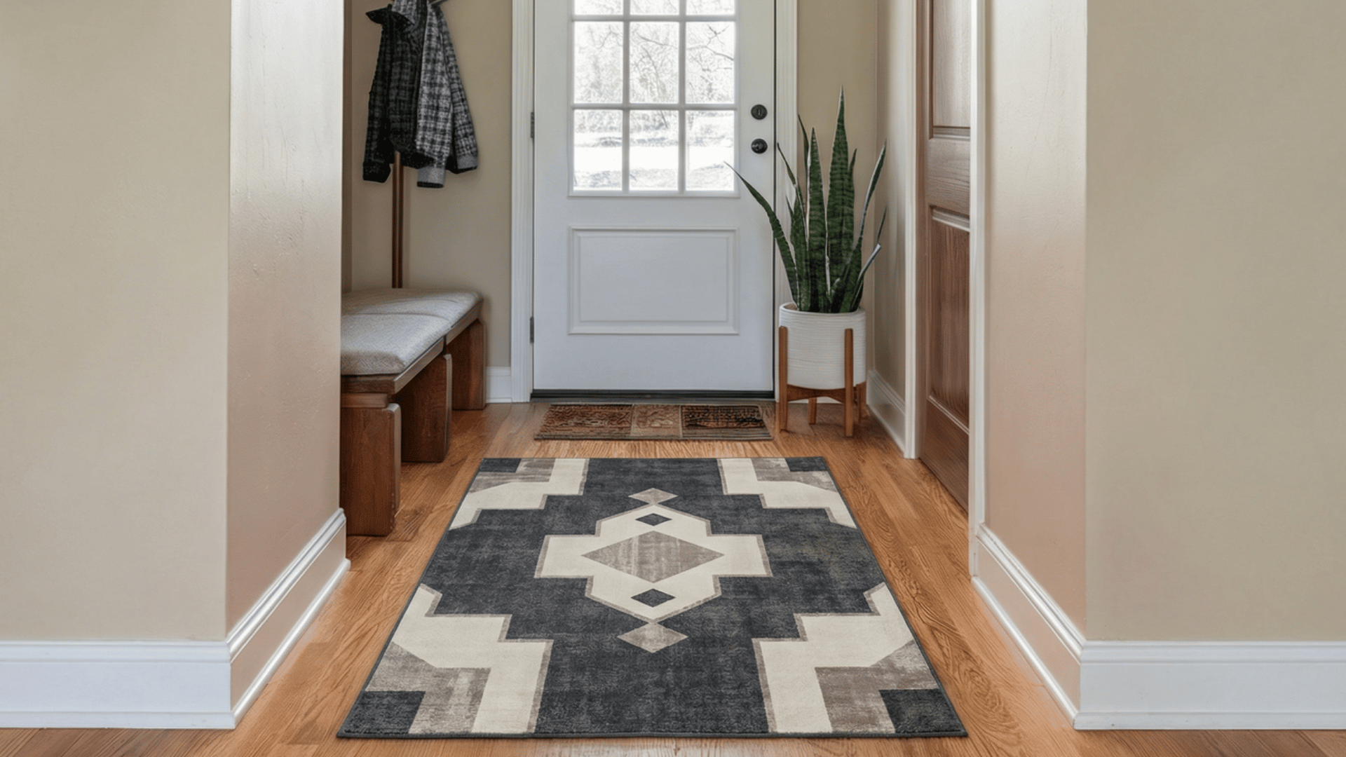 a small compact accent rug placed neatly in front of the enterance