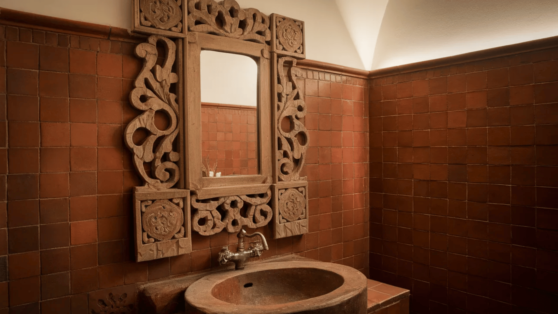 bathroom with ornate carved mirror and rustic Spanish decor