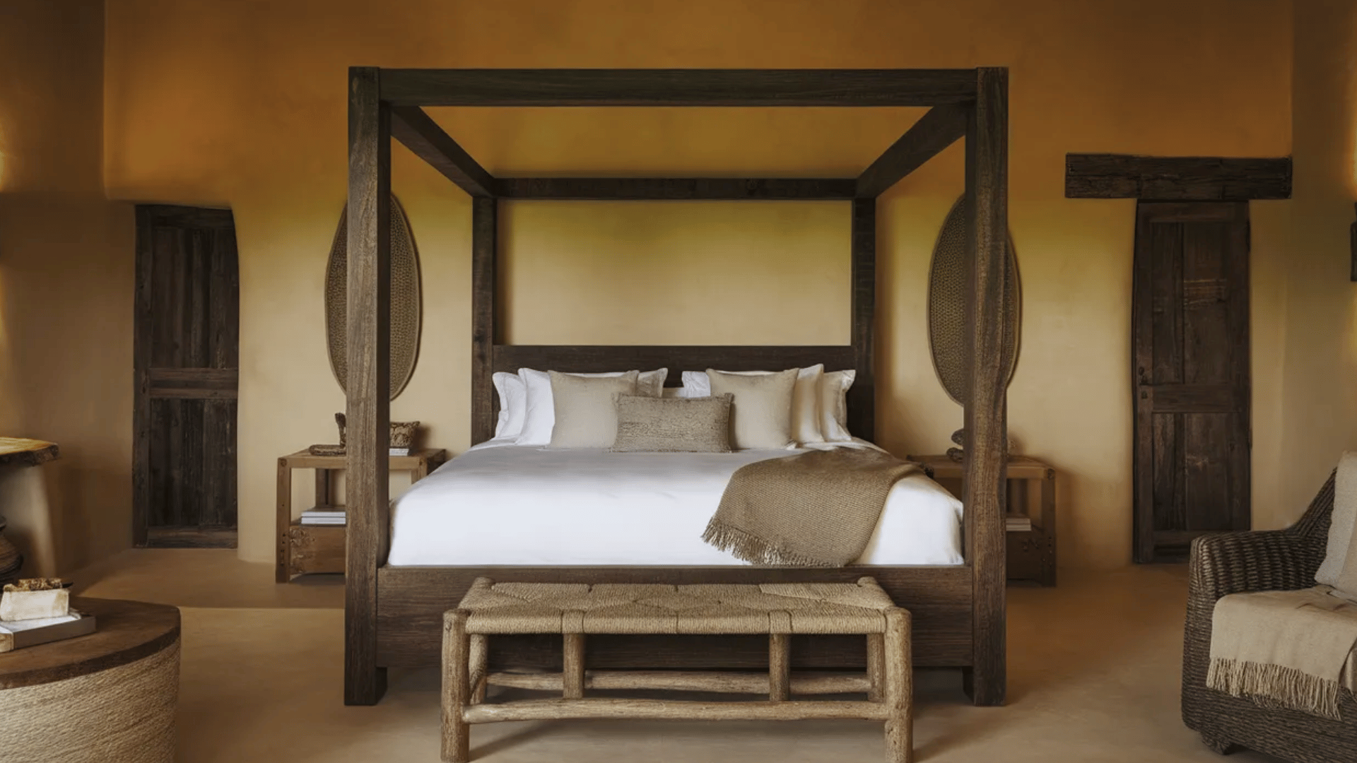 bedroom with dark wood bed frame and rustic Spanish-inspired decor