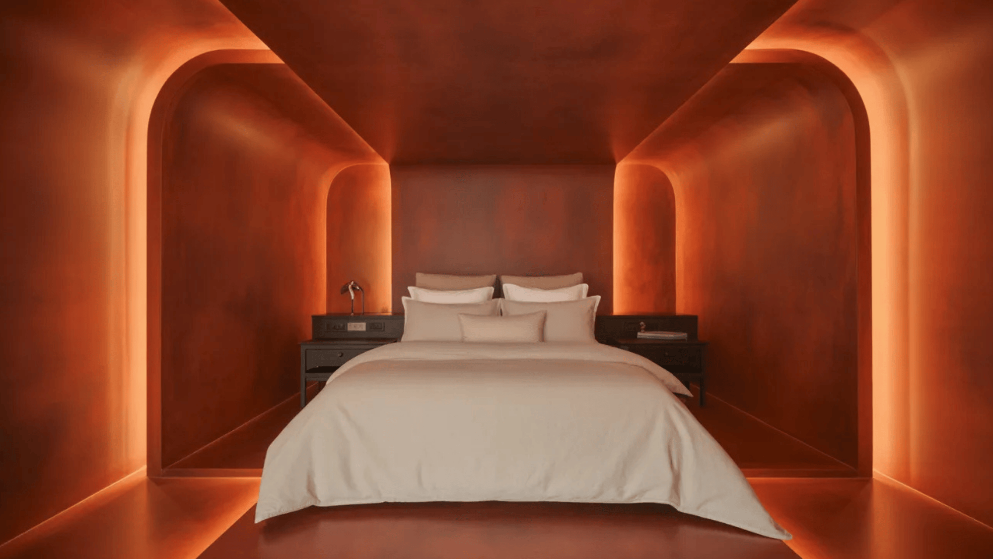 bedroom with walls in burn orange shade, with lighting