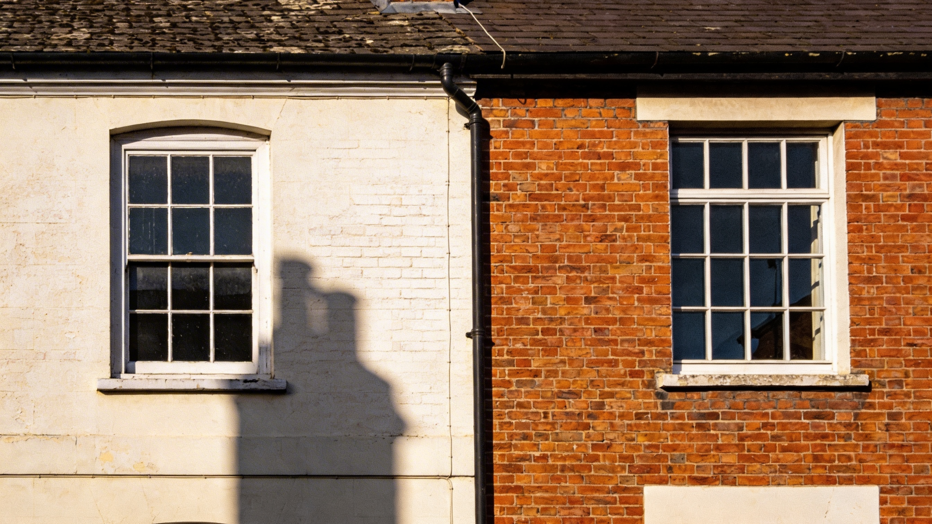 before and after limewash brick exterior transformation showing dramatic change from dark brick to soft white finish