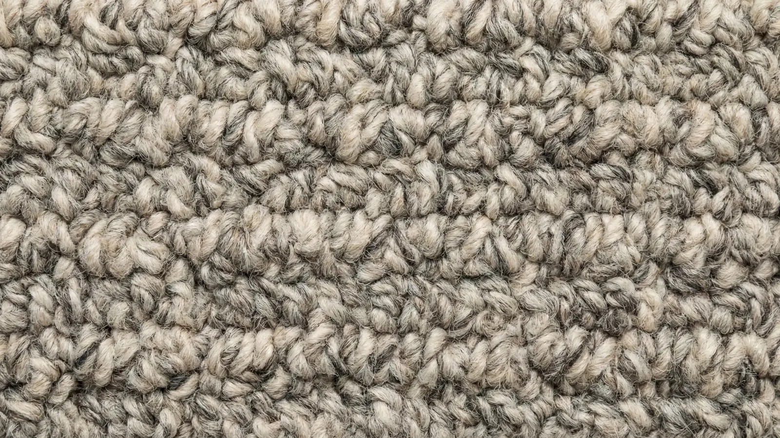 close-up of looped berber carpet fibers in ivory and grey