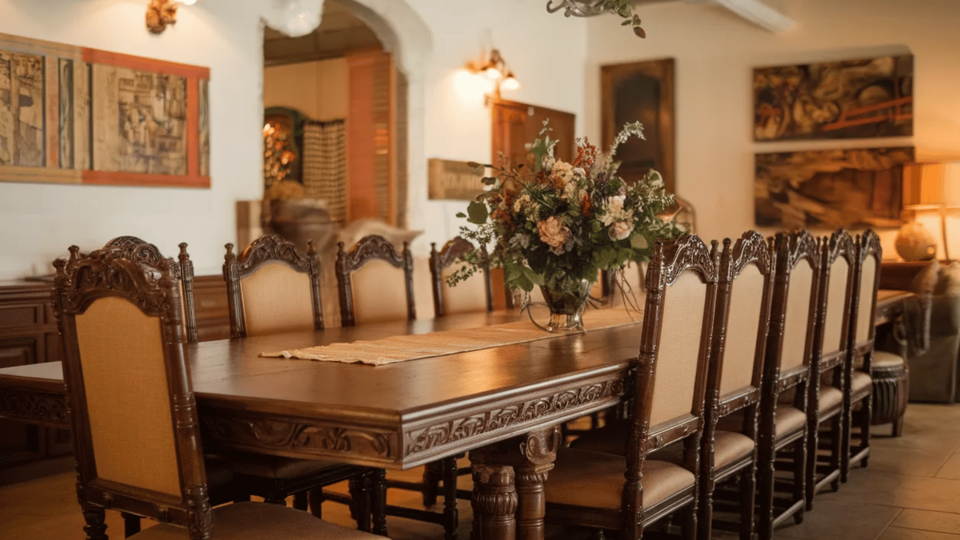 rustic wooden dining table with intricate carvings in a cozy setting.