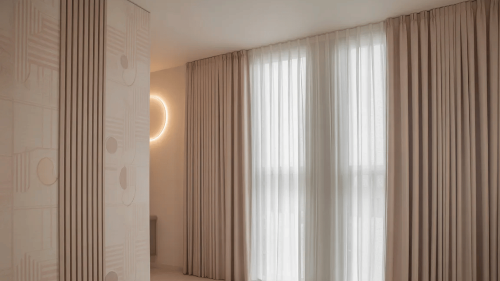 soft beige and white curtains in a minimalist bedroom with a warm, cozy vibe and modern lighting