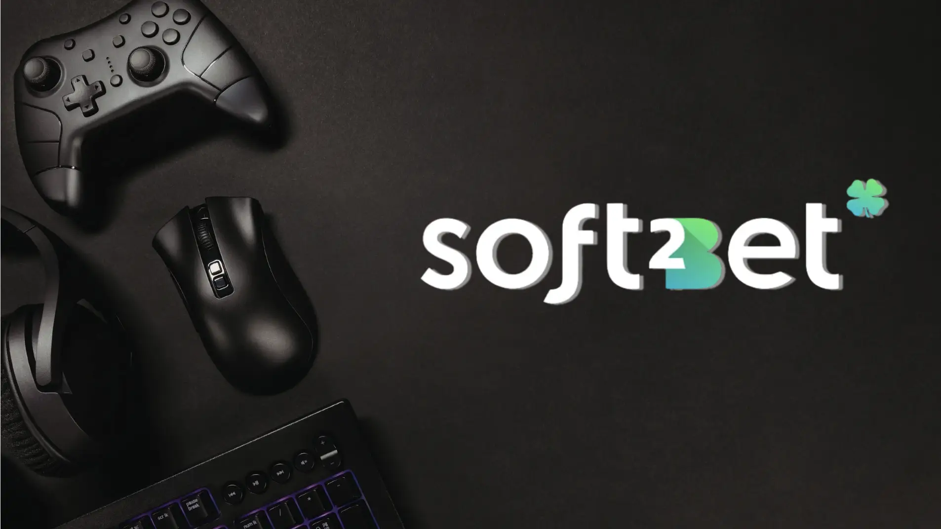 Black gaming controller, mouse, and headset on dark background with keyboard and soft2bet logo