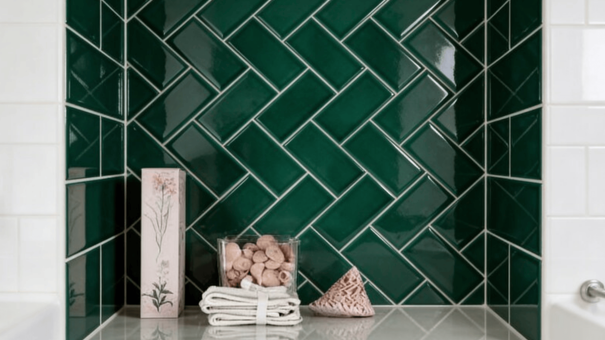 vertical herringbone tiles in deep emerald green, glossy ceramic, narrow bathroom wall, tight staggered pattern