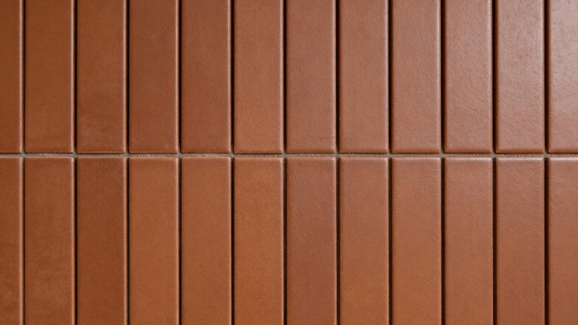 vertical stack brown textured tiles, monolithic columns, thin beige grout, natural stone grain, warm chestnut color